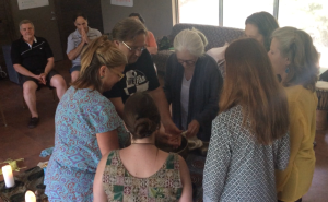 GRI Trainer Julien Devereux receiving a hand washing from the women during honoring ceremony